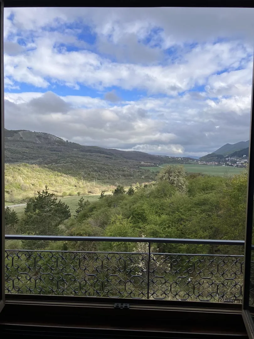 View from the wrought-iron balcony over the green valley and the mountains of Alto Sangro